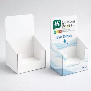 Two cardboard counter display units, one plain white and one with branded graphics for eye drops.