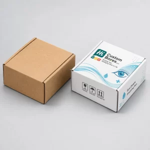 Two open corrugated mailer boxes, one natural brown Kraft and one with blue pharmaceutical branding prints.