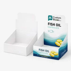 Two cardboard counter display boxes, one plain white and one printed with blue supplement product branding.