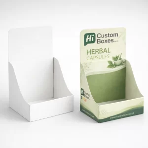 Two cardboard display boxes, one plain white and one featuring green herbal capsule product branding.